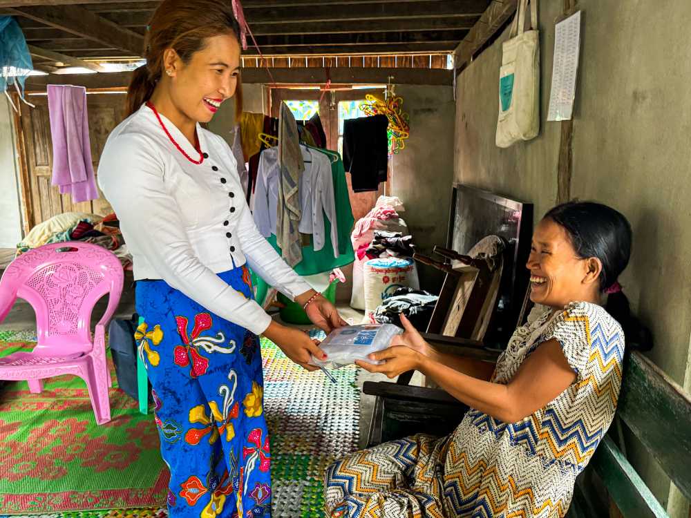 Figure 3: A pregnant woman with disabilities receives a clean delivery kit and cash assistance.  Photo ©UNFPA Myanmar