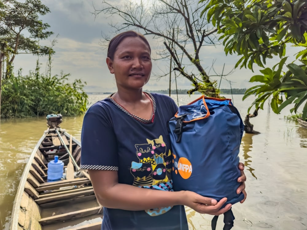 Figure 6: Woman from flood-affected community receives UNFPA's dignity kit.  Photo © UNFPA Myanmar