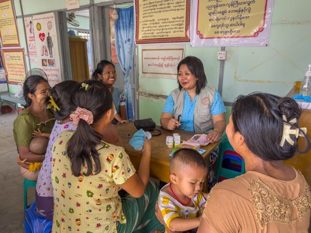 Yu Yu, a local midwife, shares information on sexual and reproductive health, including contraceptive methods, with pregnant women and lactating mothers at a static clinic in an earthquake-affected area of Mandalay. Photo © UNFPA Myanmar