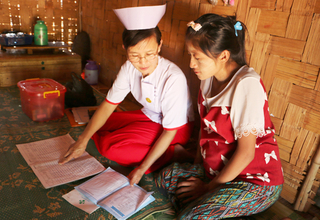 Midwife Nan Mya Phyu discusses family planning with Nan Aye Aye Han in Nam Khoke Village, Shan State, Myanmar.