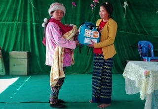 Women and girls who have fled from armed conflict in Mansi in northern Myanmar receive dignity kits at the Man Weing Gyi camp. The UNFPA dignity kits help displaced women maintain their personal hygiene and sense of dignity. 
