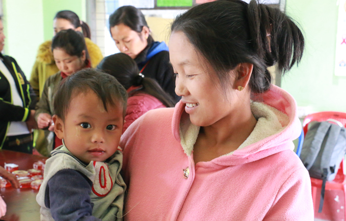 Kawt Phan and her one-year-old son relax in the women-friendly space. The better access women have to information about their health and rights, the better care they can take of themselves and their children.