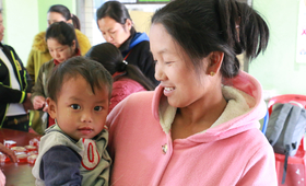 Kawt Phan and her one-year-old son relax in the women-friendly space. The better access women have to information about their health and rights, the better care they can take of themselves and their children.