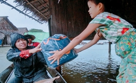 A woman receives UNFPA’s dignity kit distributed in flood-affected areas of Mon State.