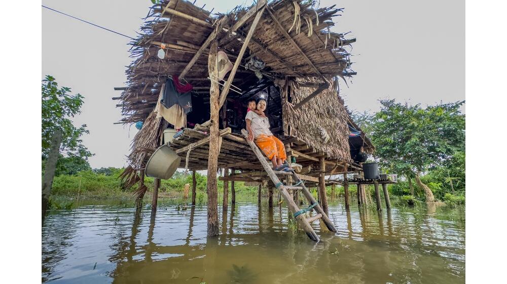 Figure 1: Pregnant woman with her child at her home in the community affected by floods in Myanmar.   Photo© UNFPA Myanmar